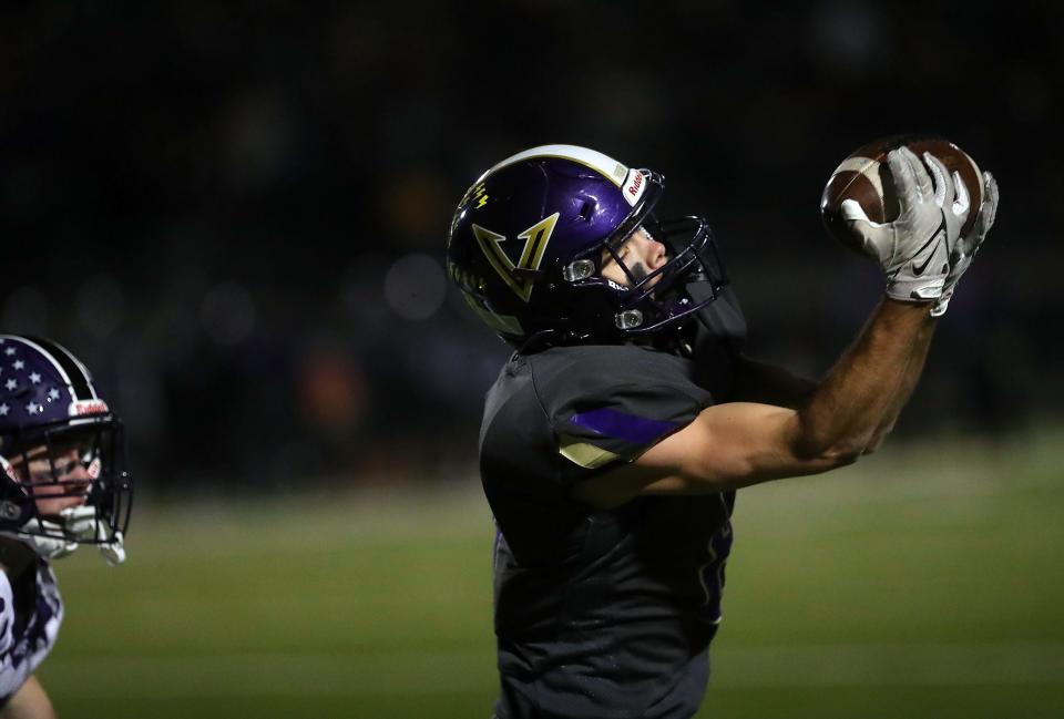 A pass is complete to North Kitsap's Logan Sloman during their 10-7 win over Anacortes on Friday, Nov. 18, 2022.