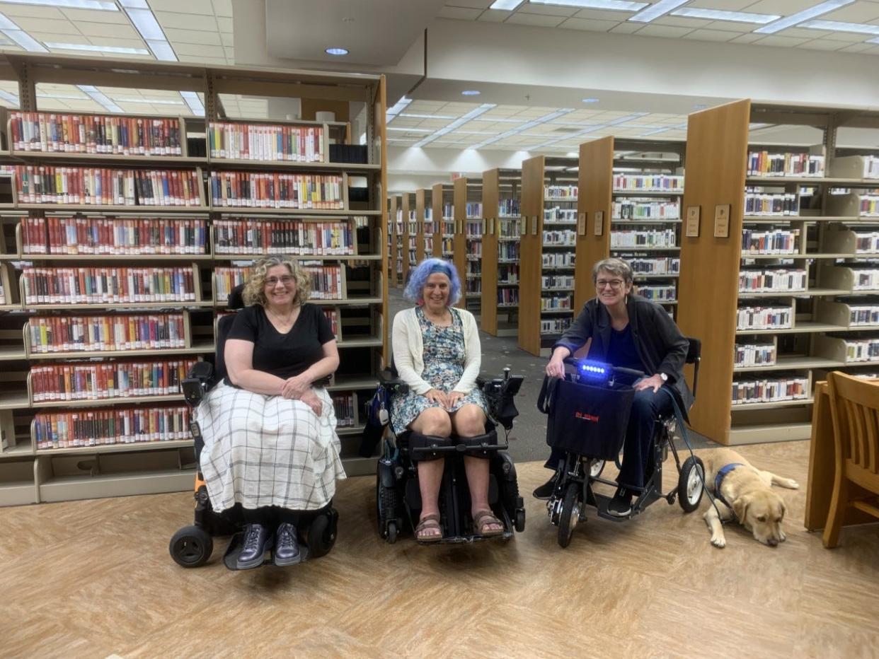 Lesley Davis, left, Susan Seizer, middle, and Susanne Even are three of the "Wheelie Women" pictured May 29, 2022, in Monroe County Public Library, the donation site for the Mobility Aids Lending Library.