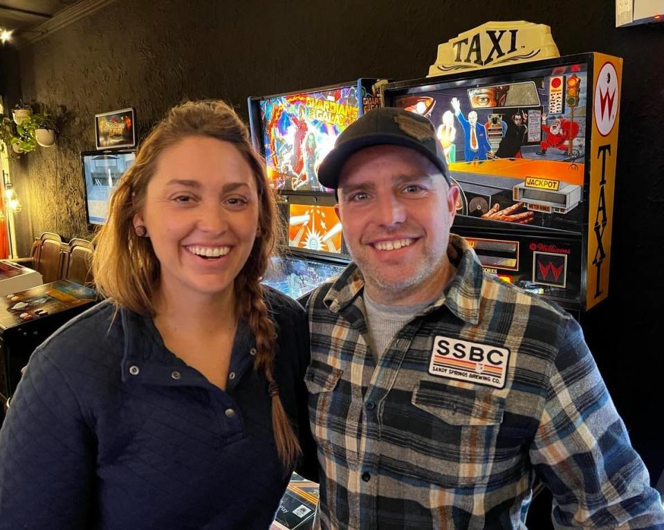 Amanda and Andy Conrad are shown in the arcade next to Sandy Springs Brewing Co. in Minerva. The arcade was added to the couple's brewery business late last year.