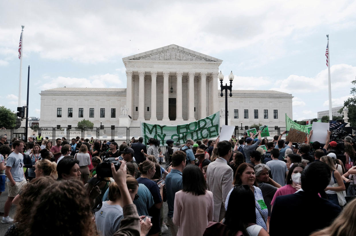 Demonstrators gather outside the United States Supreme Court as the court rules in the Dobbs v Women's Health Organization abortion case