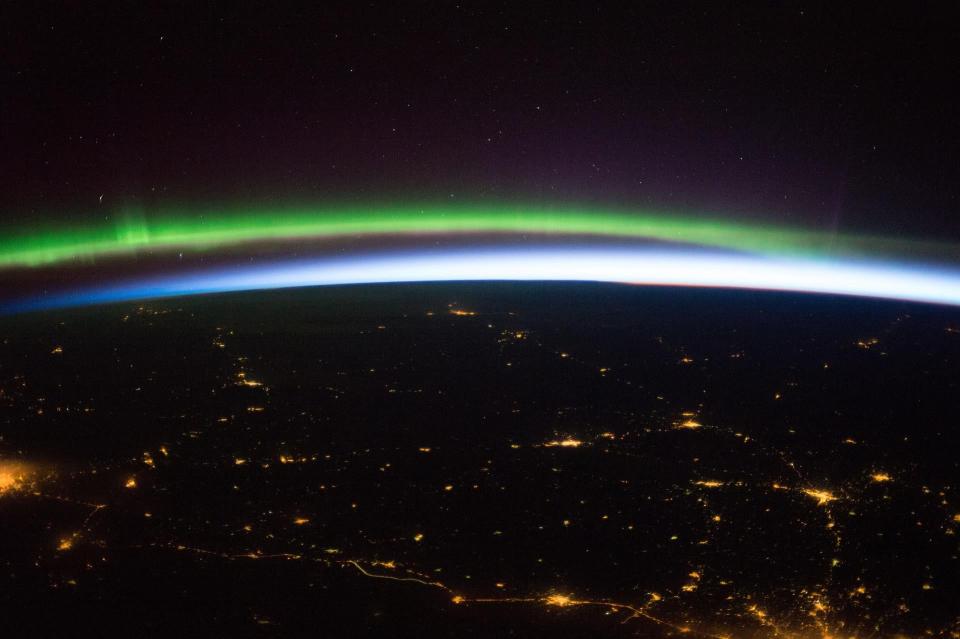 an aurora over city lights