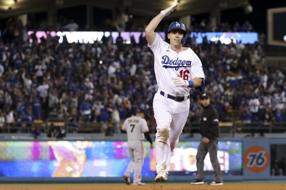 Dodgers catcher Will Smith pats his head as he rounds the bases after hitting a two-run home run against the Giants