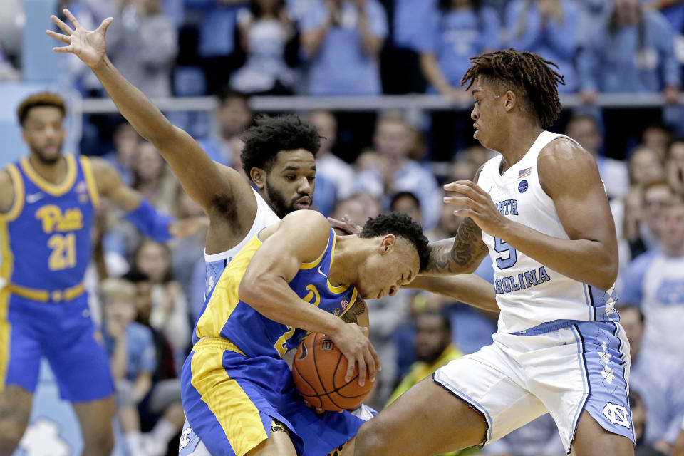 North Carolina guard Jeremiah Francis, left, and forward Armando Bacot (5) guard Pittsburgh guard Trey McGowens (2) during the first half of an NCAA college basketball game in Chapel Hill, N.C., Wednesday, Jan. 8, 2020. (AP Photo/Gerry Broome)