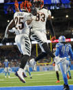 Cincinnati Bengals running back Chris Evans (25) and wide receiver Tyler Boyd (83) celebrate after Evans' touchdown during the first half of an NFL football game against the Detroit Lions, Sunday, Oct. 17, 2021, in Detroit. (AP Photo/Paul Sancya)