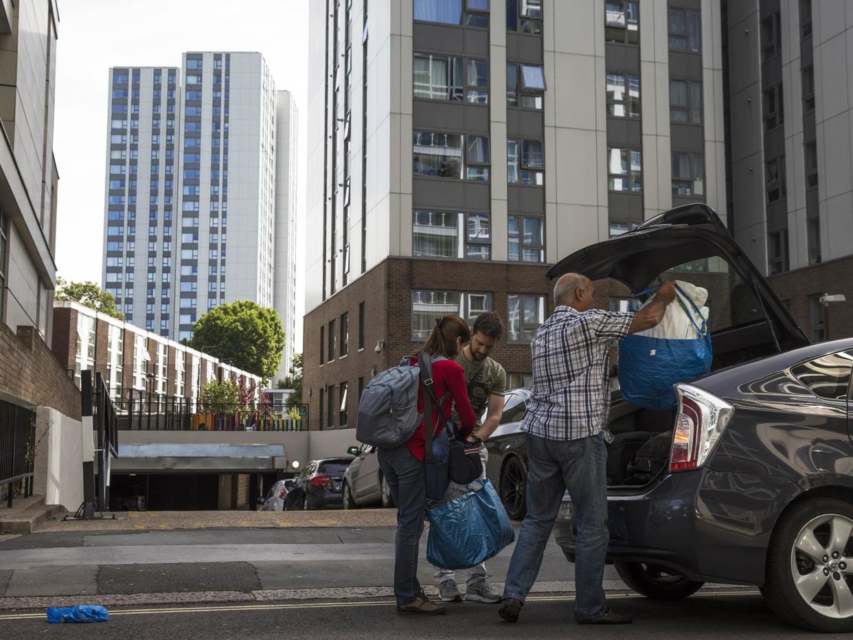 People pack their belongings after evacuating high rise building: Getty Images