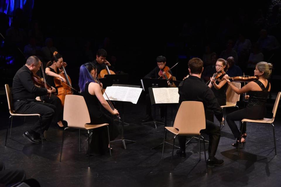 An ensemble of musicians from the Chamber Music Festival of Lexington and the Central Kentucky Youth Orchestras -- Burchard Tang, Priscilla Lee, Skye Park (back to camera), Nathan Tantasook, Jeffrey Shen, Nathan Cole (back to camera) Madeline Farrar and Akiko Tarumoto -- played Medelssohn’s Octet in 2018 at the Pam Miller Downtown Arts Center in Lexington, KY. Rich Copley/rcopley@herald-leader.com