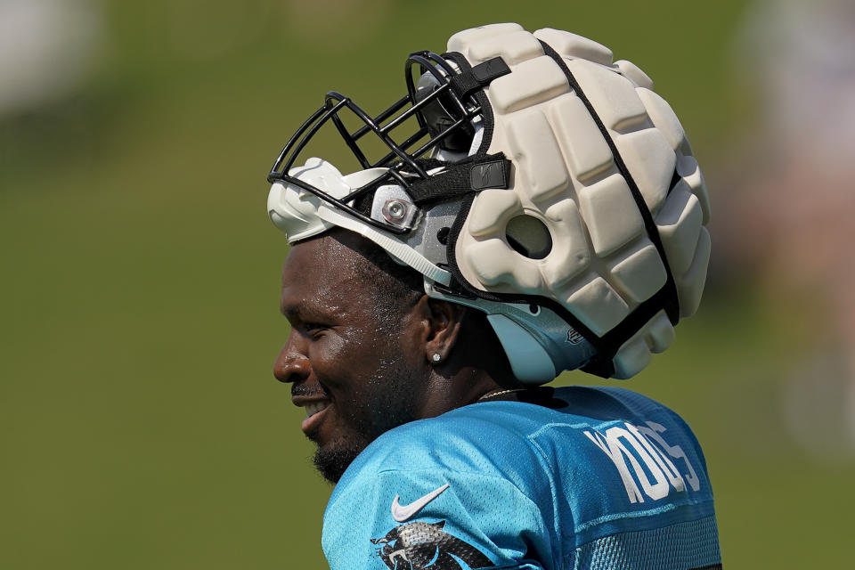 Carolina Panthers' Xavier Woods watches during NFL football team's training camp wearing his helmet with a protective covering at Wofford College on Wednesday, Aug. 3, 2022, in Spartanburg, S.C. The NFL has made the use of Guardian Caps mandatory up until the second week of the preseason for offensive and defensive lineman, linebackers and tight ends. (AP Photo/Chris Carlson)