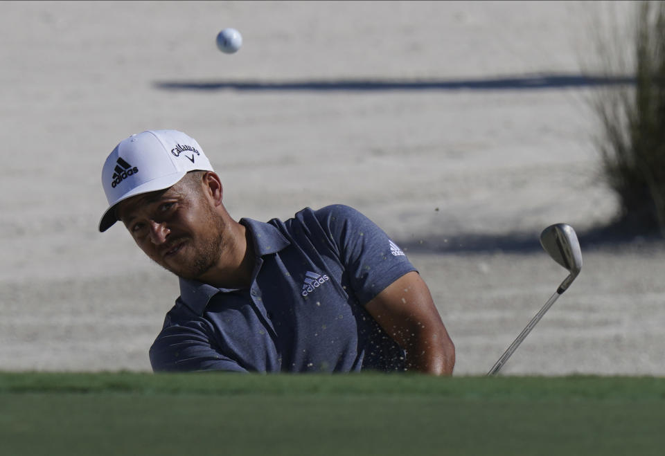 Xander Schauffele, of the United States, watches his hit from the sand on the third hole during the first round of the Hero World Challenge PGA Tour at the Albany Golf Club, in New Providence, Bahamas, Thursday, Dec. 2, 2021.(AP Photo/Fernando Llano)