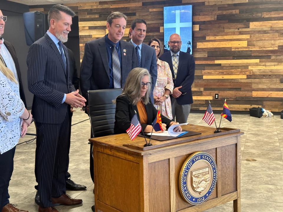 Gov. Katie Hobbs signs SB 1136, adding rights for foster children, on Sept. 14, 2023, at Church of Grace in Mesa.