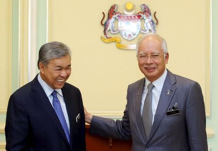 Malaysia's Prime Minister Najib Razak (R) announces the appointment of new Deputy Prime Minister Ahmad Zahid Hamidi (L) following a cabinet reshuffle in Putrajaya, Malaysia, July 28, 2015. REUTERS/ The New Straits Times Press/ Mohd Fadli Hamzah