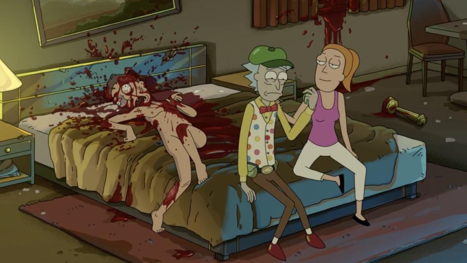 Summer consoles a distraught Yo-Yo Rick as a bloody body lies behind them on a hotel bed