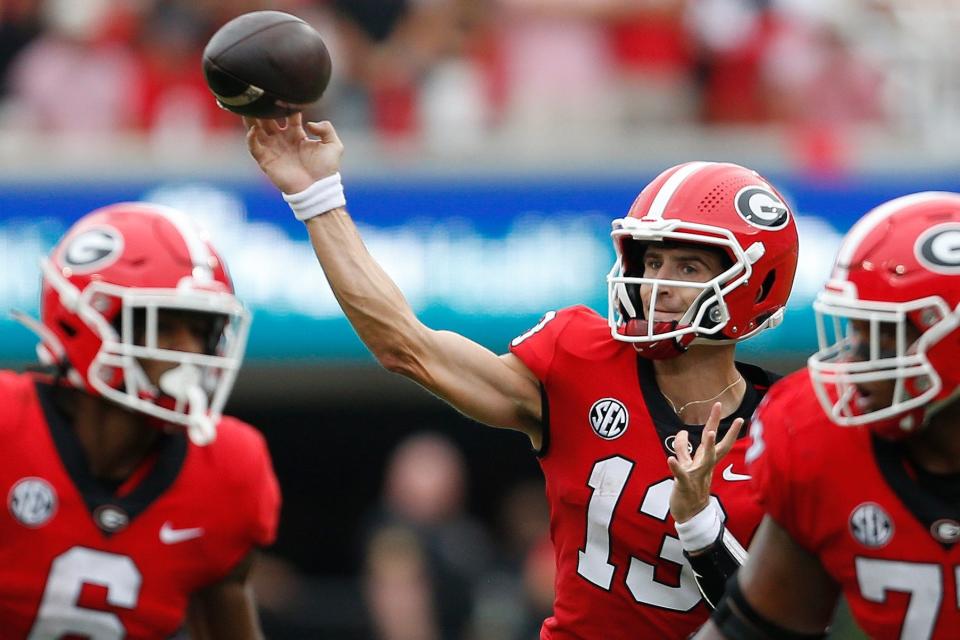 Georgia quarterback Stetson Bennett (13) throws a touchdown during the first half of a college football game between Samford and Georgia in Athens, Ga., on Saturday, Sept. 10, 2022.