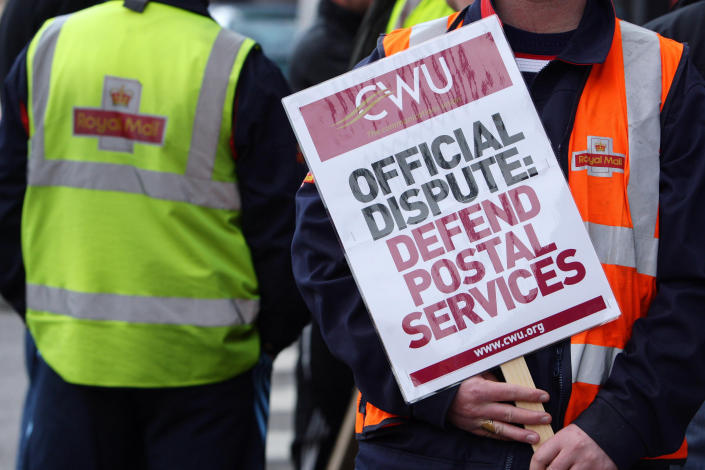 Royal Mail staff gather outside the main delivery office in Stockport on the second day of a two day nationwide strike.