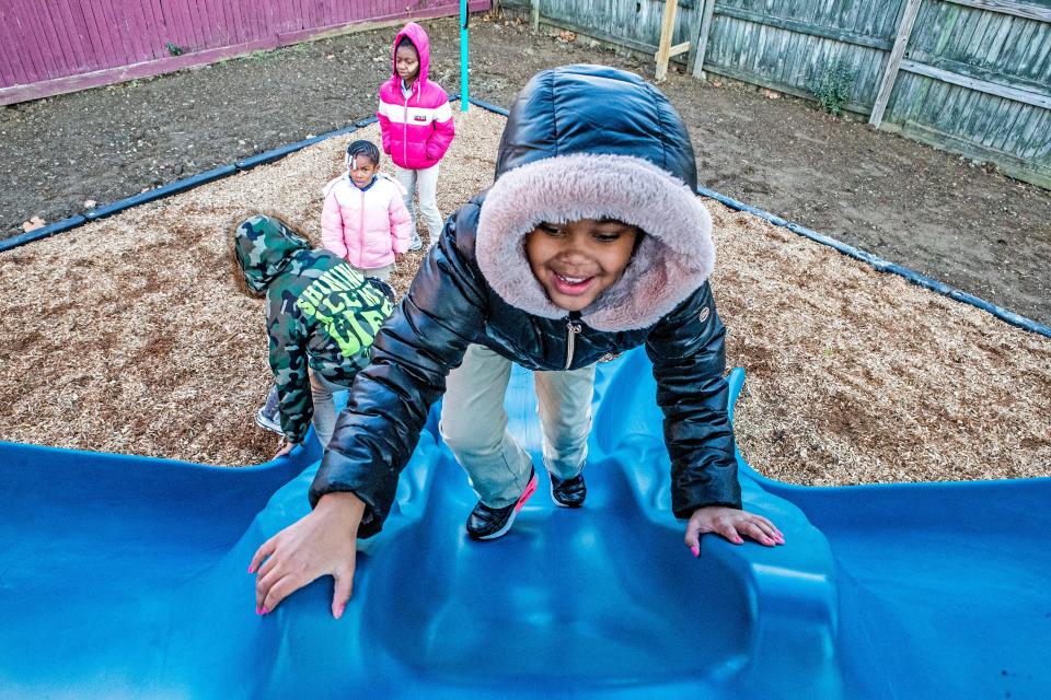 Students of the Neighborhood House Inc. School Age Program enjoy the slides of the new community-designed playground in Wilmington, Thursday, Dec. 1, 2022. The playground was a colloborate effort by Neighborhood House, community members, kids, Discover, Delaware Community Foundation and KABOOM!