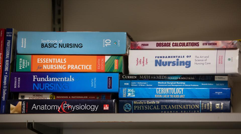 Nursing books line the shelves in the classroom at Cincinnati State Technical and Community College on  Wednesday, Feb. 23, 2022. The school hopes to offer a bachelor's degree in nursing in the fall of 2023.