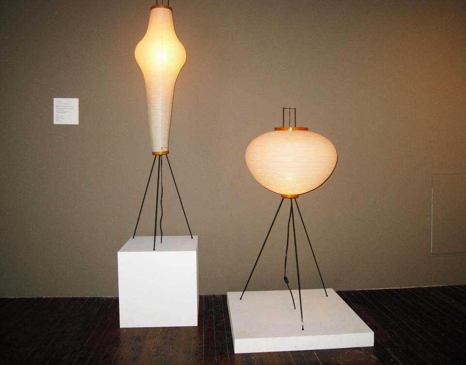 This April 20, 2013 photo shows two lighting sculptures on display at the Isamu Noguchi Museum in Long Island City, N.Y. Japanese lanterns used for ancestor worship inspired the late Noguchi to design the lamps, which he called akari, the Japanese word for light. His widely imitated designs became classics of mid-20th century modern home design and the original designs are still sold by the Noguchi Museum and Foundation. (AP Photo/Beth J. Harpaz)