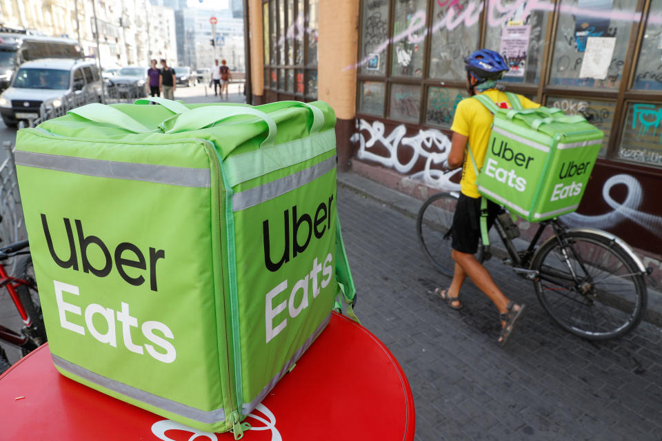 An Uber Eats food delivery courier pulls a bicycle in central Kiev, Ukraine September 9, 2019. REUTERS/Valentyn Ogirenko