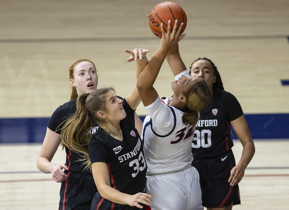 Arizona forward Lauren Ware (32) reaches for a rebound as Stanford guard Hannah Jump (33) tries to keep her from getting the ball during an NCAA college basketball game Friday, Jan. 1, 2021, in Tucson, Ariz. (Josh Galemore/Arizona Daily Star via AP)