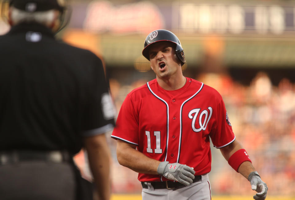 Washington Nationals' Ryan Zimmerman (11) argues a call with home plate umpire Larry Vanover, left, after Atlanta Braves starting pitcher Alex Wood struck him out in the first inning of a baseball game on Saturday, April 12, 2014, in Atlanta. (AP Photo/Jason Getz)