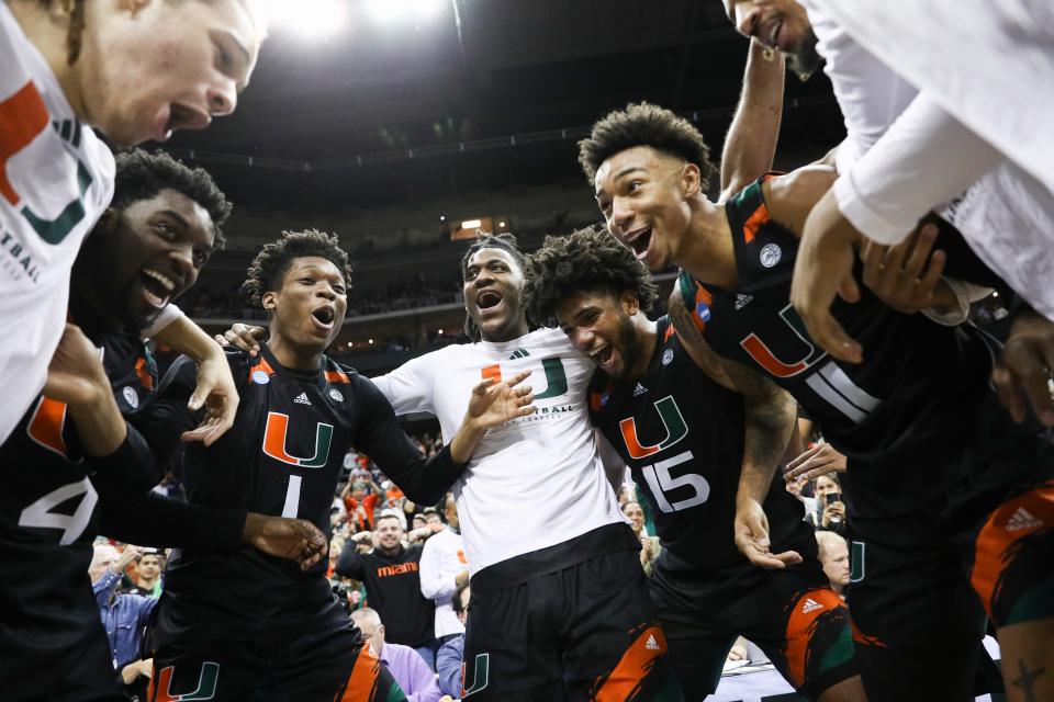 Miami (Fla.) players celebrate following their defeat of Houston in the Sweet 16 of the NCAA men's tournament at T-Mobile Center.