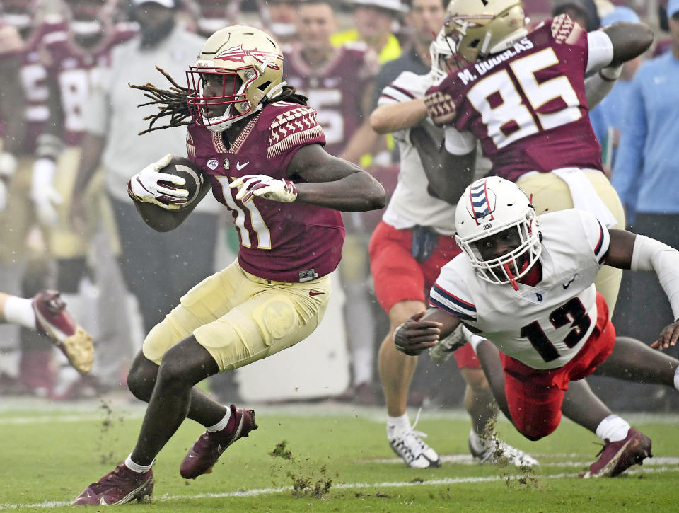 Aug 27, 2022; Tallahassee, Florida; Florida State Seminoles wide receiver Sam McCall (11) runs the ball against Duquesne Dukes defensive back CJ Barnes (13) during the first half at Doak S. Campbell Stadium. Melina Myers-USA TODAY Sports