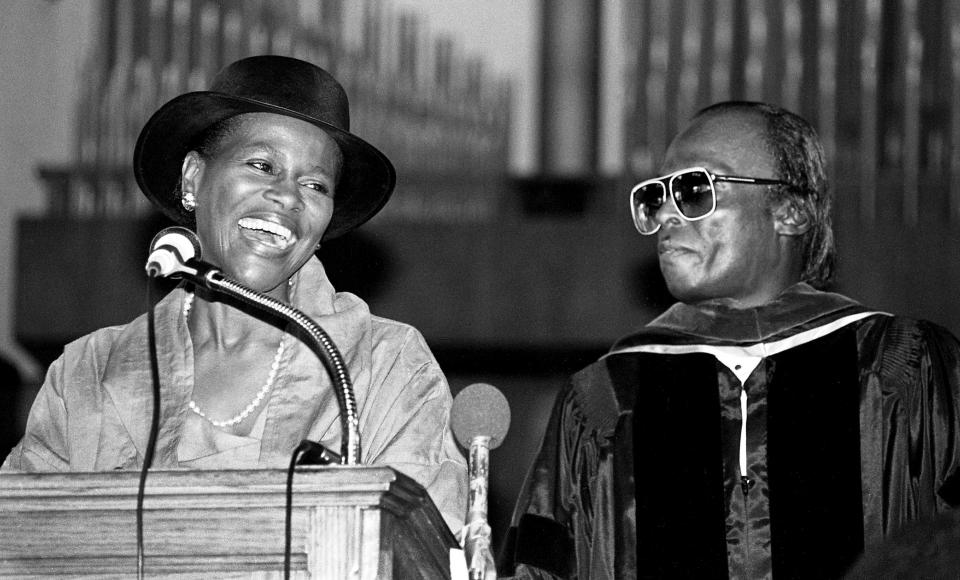 Award-winning actress Cicely Tyson, left, speaks for her husband, composer, arranger and trumpeter Miles Davis after he was presented a honorary doctor of humane letters degree during Fisk University convocation on campus Sept. 8, 1983.