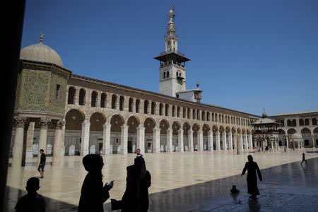 People walk in front of the Umayyad mosque in Damascus, Syria, September 14, 2018. REUTERS/Marko Djurica