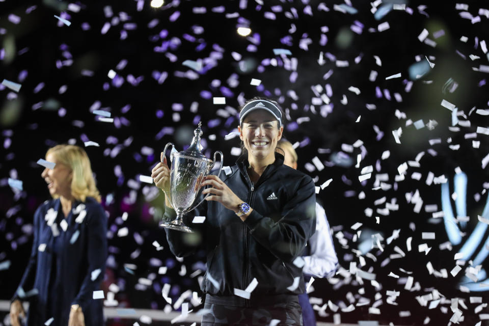 Garbiñe Muguruza, of Spain, holds the trophy during an awarding ceremony after defeating Anett Kontaveit, of Estonia, at the final match of the WTA Finals tennis tournament in Guadalajara, Mexico, Wednesday, Nov. 17, 2021. (AP Photo/Refugio Ruiz)