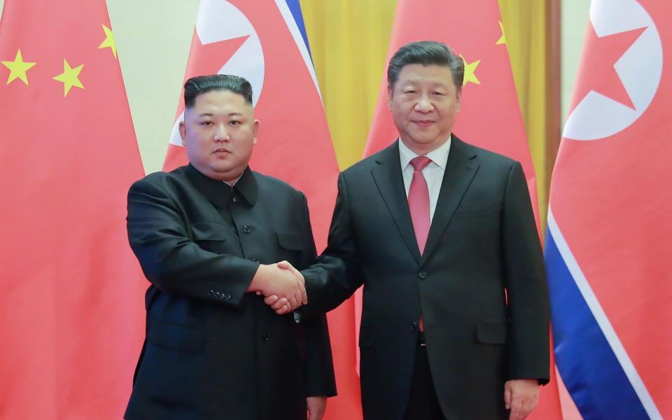 North Korea's visiting leader Kim Jong-un shakes hands with China's President Xi Jinping in Beijing in January - AFP