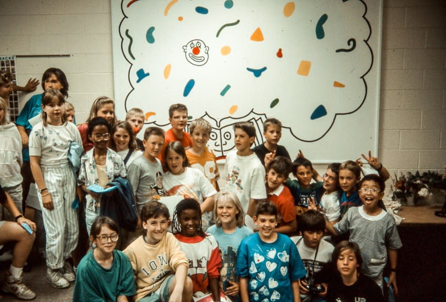 Horn Elementary School students pose in front of the Haring mural in progress in 1989 (photo courtesy of Colleen Ernst).