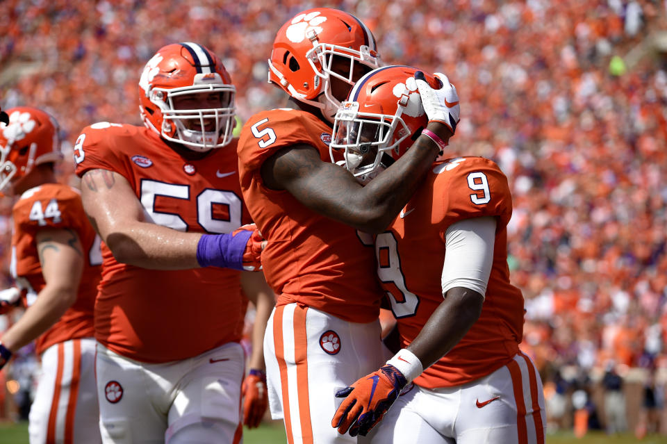 Clemson's Travis Etienne (9) celebrates his touchdown with Tee Higgins (5) and Gage Cervenka during the second half of an NCAA college football game against Syracuse, Saturday, Sept. 29, 2018, in Clemson, S.C. Clemson won 27-23. (AP Photo/Richard Shiro)