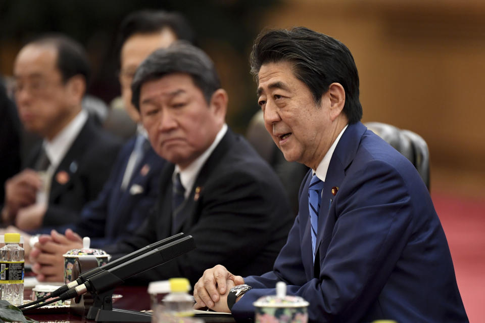 Japan's Prime Minister Shinzo Abe talks to China's President Xi Jinping during a meeting at the Great Hall of the People in Beijing, Monday, Dec. 23, 2019. (Noel Celis/Pool Photo via AP)