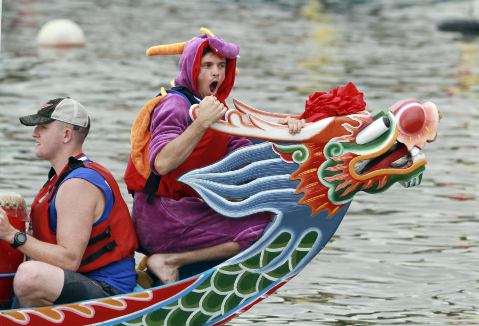 <p>A boat captain wears a dragon costume during a traditional Chinese Dragon Boat race in Taipei, Taiwan, Saturday, June 20, 2015. Dragon boat races are in remembrance of Chu Yuan, an ancient Chinese scholar-statesman, who drowned in 277 B.C. while denouncing government corruption.  (AP Photo/Chiang Ying-ying)</p>
