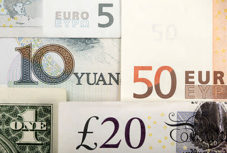 Arrangement of various world currencies including Chinese Yuan, US Dollar, Euro, British Pound, shot January 25, 2011. REUTERS/Kacper Pempel/Illustration/File Photo