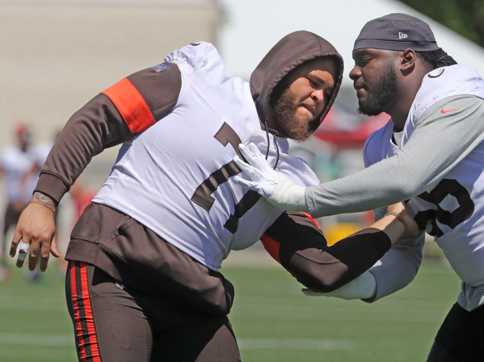 Browns left tackle Jedrick Wills Jr., left, works on pass blocking techniques on Aug. 2, 2021 in Berea.