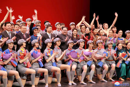 North Korean leader Kim Jong Un, his wife Ri Sol Ju and Song Tao, head of the International Department of Communist Party of China (CPC) Central Committee, applaud with ballet dancers in this undated photo released by North Korea's Korean Central News Agency (KCNA) in Pyongyang April 17, 2018. KCNA/via Reuters