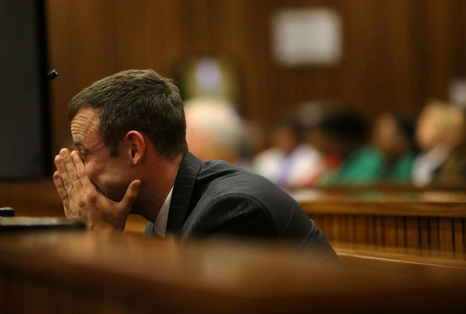 Oscar Pistorius sits in the dock as he listens to cross questioning about the events surrounding the shooting death of his girlfriend Reeva Steenkamp, in court during his trial in Pretoria, South Africa, Monday, March 10, 2014. Pistorius is charged with the shooting death of his girlfriend Steenkamp in 2013. (AP Photo/Siphiwe Sibeko, Pool)