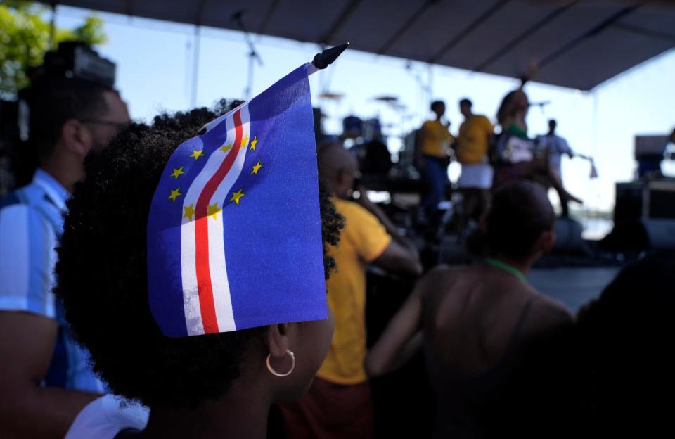 A young girl holds a Cape Verdean flag in her hair at the 2022 Cape Verdean Independence Day Festival in Providence.