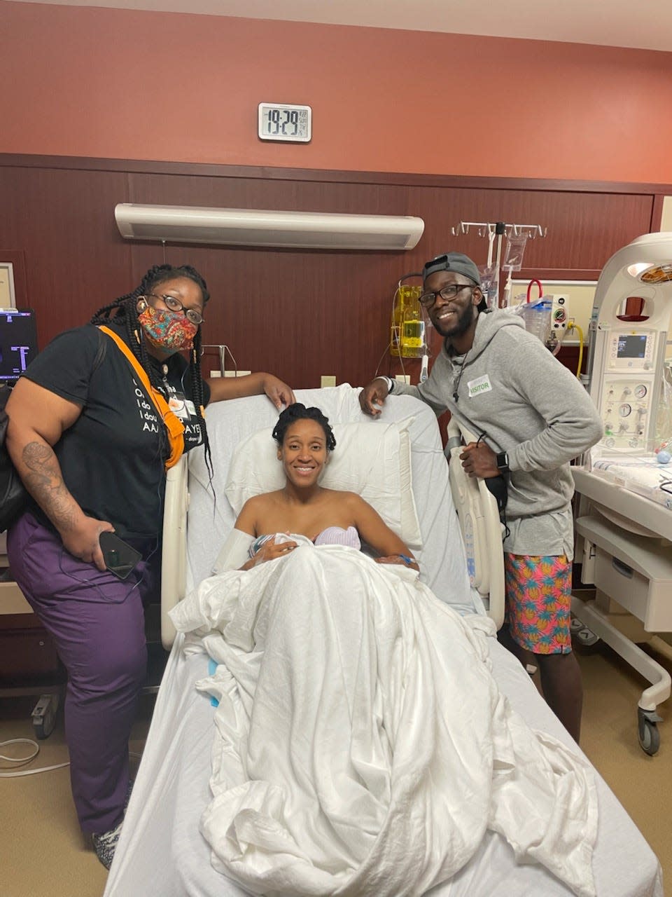 Calvis Jones, left, served as a doula for mother Jaleesa Conyers, center, and her fiance Jeremy Dixon for the birth of their son Jahari in August.