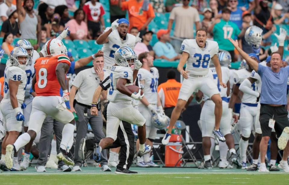 Middle Tennessee State Blue Raiders wide receiver DJ England-Chisolm (3) scores on a long pass return in the fourth quarter as Miami Hurricanes cornerback DJ Ivey (8) gives chase at Hard Rock Stadium in Miami Gardens on Saturday, September 24, 2022.