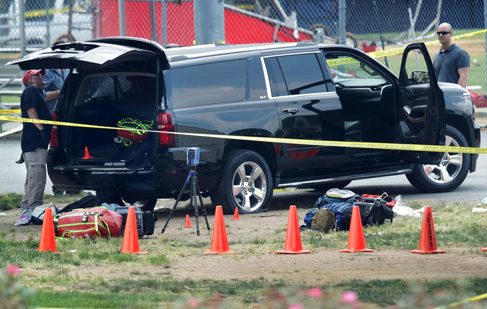 <p>Investigators survey a black SUV with a flat tire and a hole on its windshield outside the Eugene Simpson Stadium Park where a shooting had happened June 14, 2017 in Alexandria, Va. (Photo: Alex Wong/Getty Images) </p>