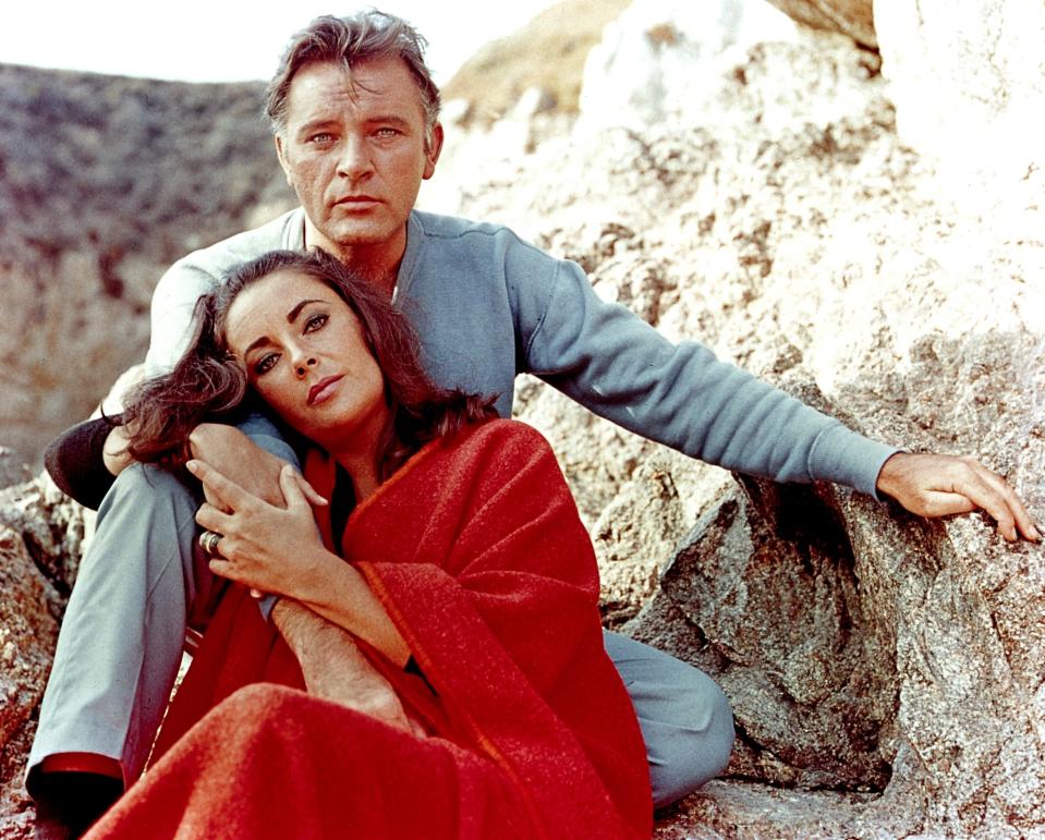 Elizabeth Taylor and Richard Burton pose in between takes while filming "The Sandpiper" circa 1965