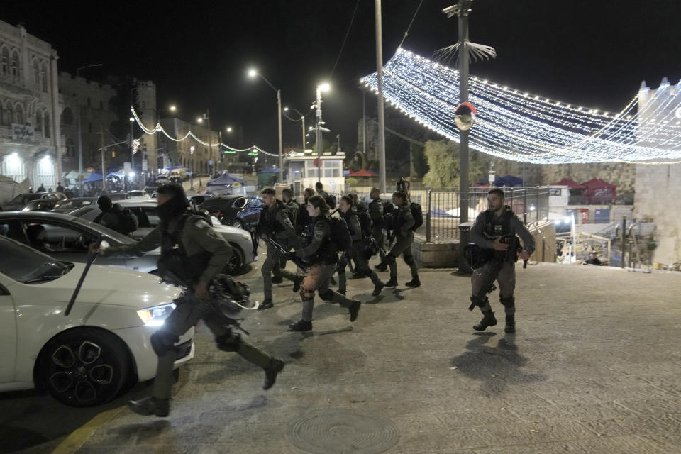 Israeli Border Police are deployed near the Damascus Gate to the Old City of Jerusalem during a raid by police at the Al-Aqsa Mosque compound, Wednesday, April 5, 2023. Palestinian media reported police attacked Palestinian worshippers, raising fears of wider tension as Islamic and Jewish holidays overlap.(AP Photo/Mahmoud Illean)