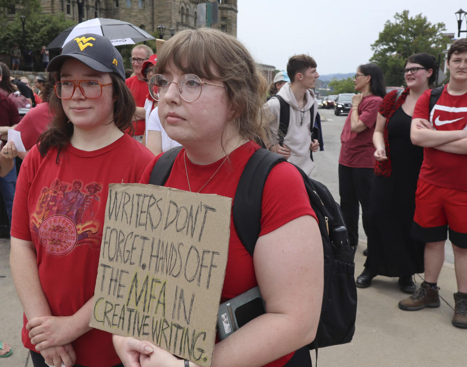 West Virginia University creative writing master's student Kelly Ward and alumna Anna Schles attend a protest outside the Mountainlair student center against proposed cuts to programs in world languages, creative writing and more amid a $45 million budget deficit Morgantown, W.Va., on Monday, Aug. 21, 2023. (AP Photo/Leah Willingham)