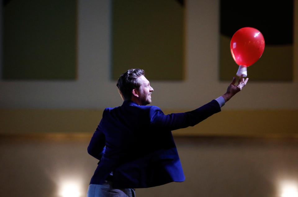 Nathan Cook, choir director at Parkview High School and last year's SPS Teacher of the Year, uses a balloon during his keynote speech at the Celebrate SPS event on Monday, April 17, 2023.