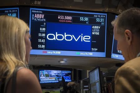 A screen displays the share price for pharmaceutical maker AbbVie on the floor of the New York Stock Exchange July 18, 2014. REUTERS/Brendan McDermid