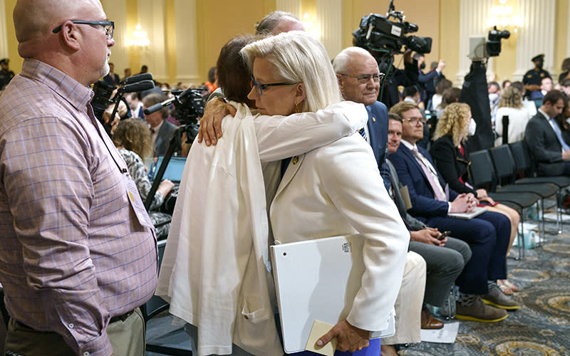 People hug following a July 21 committee hearing