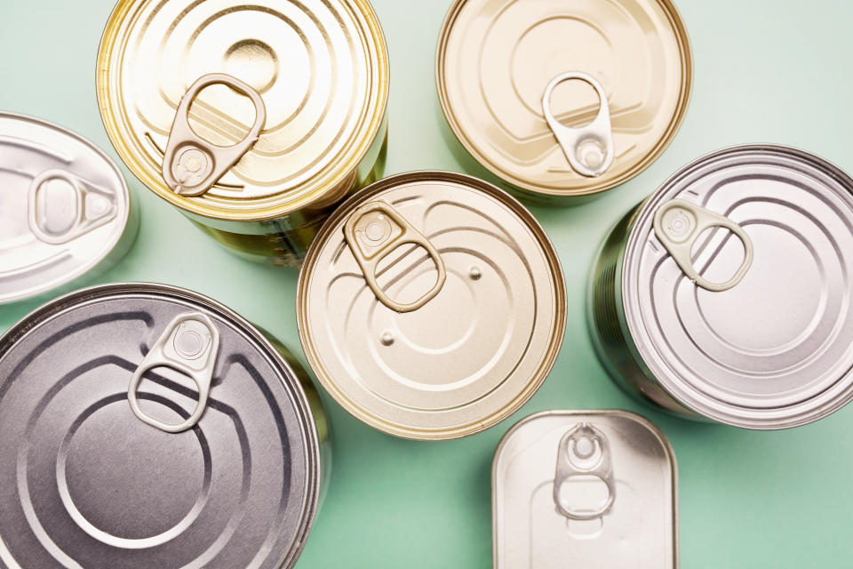 canned goods lined up side by side on a bright green background