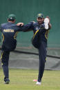 Pakistan’s Shahid Afridi, right, stretches during a practice session ahead of the Asia Cup tournament in Dhaka, Bangladesh, Sunday, Feb. 23, 2014. Pakistan plays Sri Lanka in the opening match of the five-nation one day cricket event that begins Tuesday.(AP Photo/A.M. Ahad)