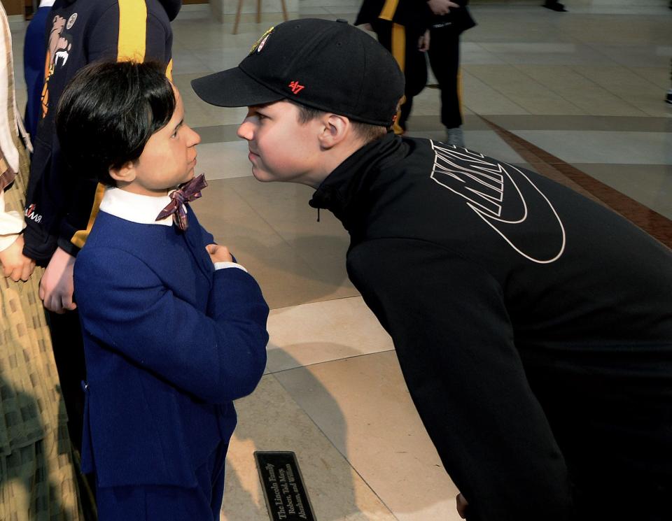 Robert Maliarenko, 13, of Ukraine, gets a close look at the Tad Lincoln figure Thursday, March 23, 2023, at the Abraham Lincoln Presidential Library and Museum. Maliarenko was part of a Ukrainian youth hockey team visiting the States. 